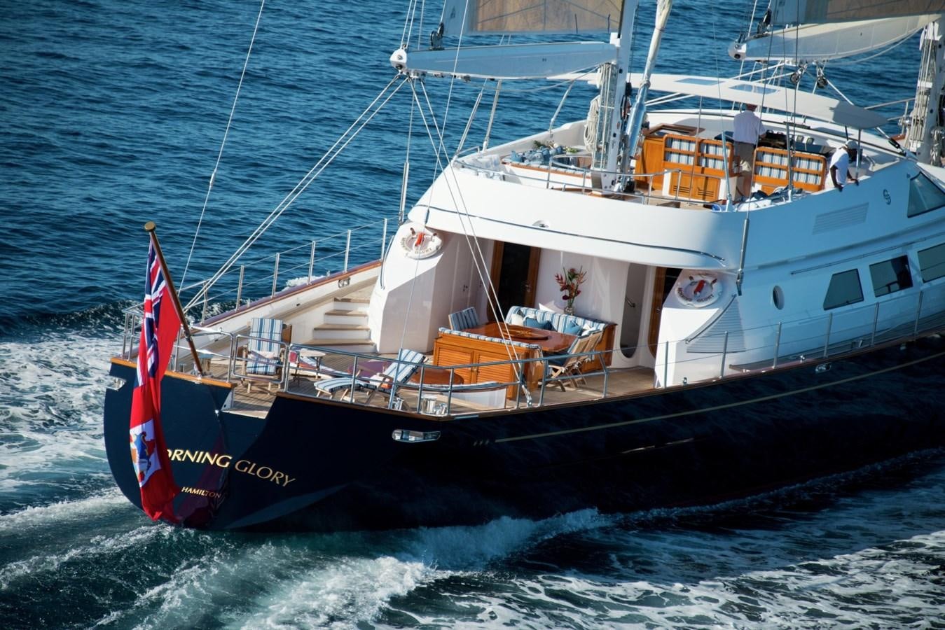 a boat with a red and white stripe on the front aboard MORNING GLORY Yacht for Sale