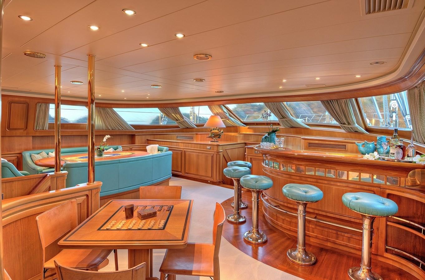 a bar with stools and tables aboard MORNING GLORY Yacht for Sale