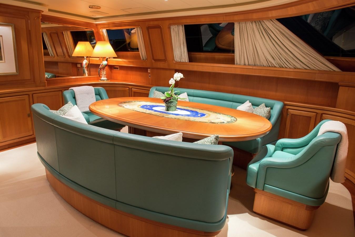 a room with a couch and a table and chairs aboard MORNING GLORY Yacht for Sale