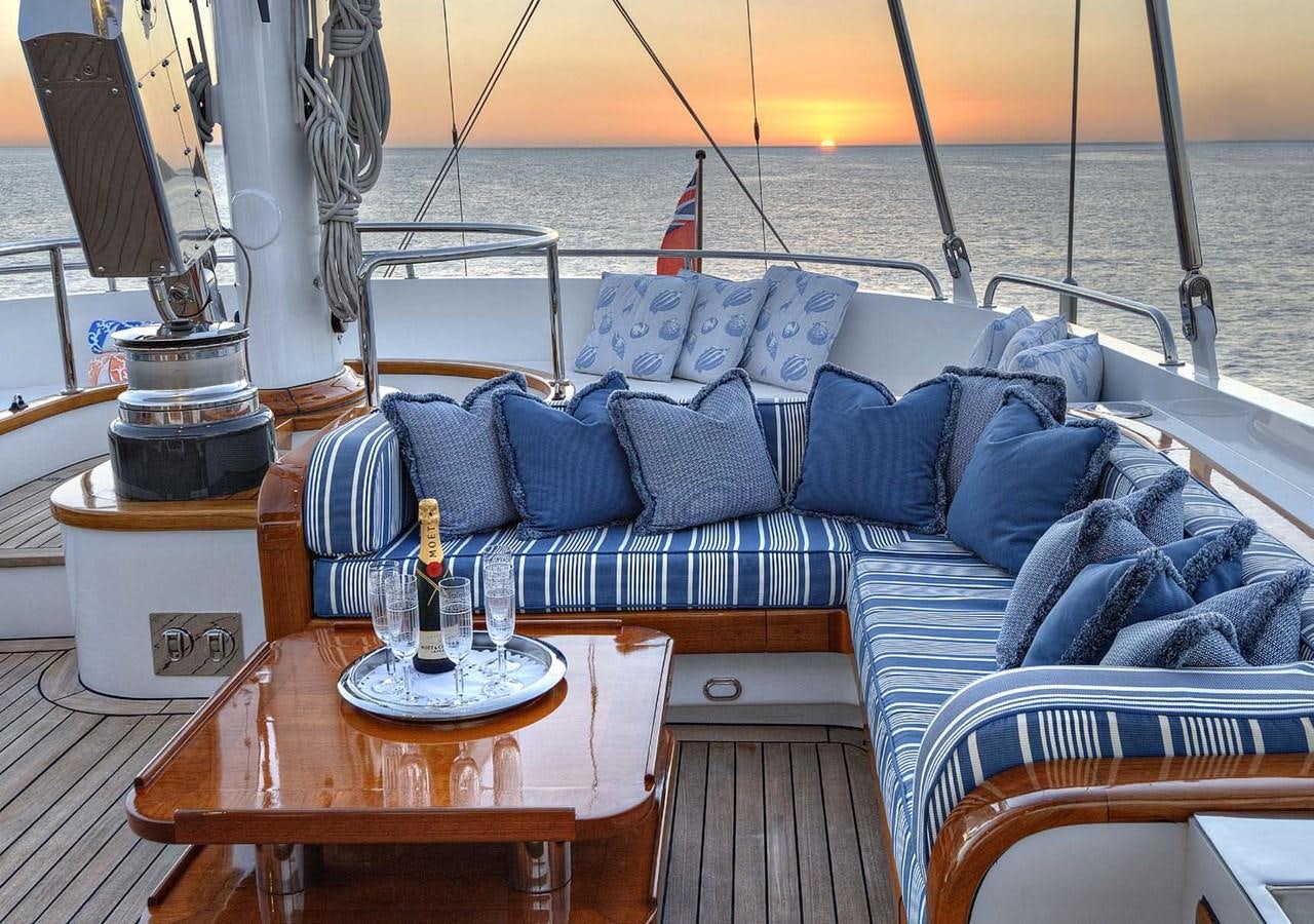 a boat with pillows and a table aboard MORNING GLORY Yacht for Sale