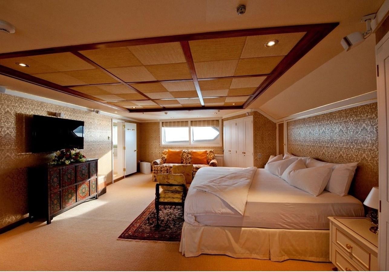a large bedroom with a fireplace aboard LANGKAWI LADY Yacht for Sale