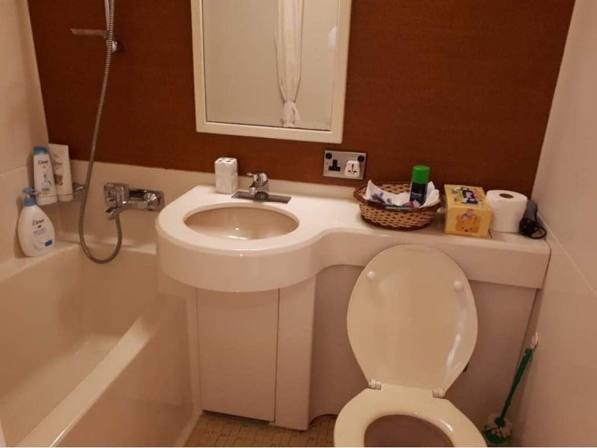 a bathroom with a toilet sink and tub aboard LANGKAWI LADY Yacht for Sale