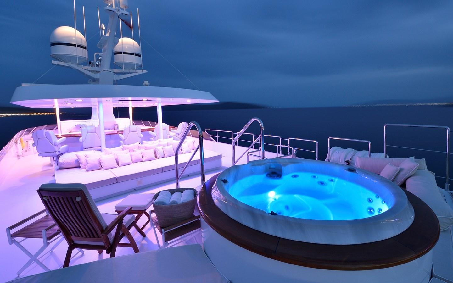 a swimming pool with chairs around it aboard AZZURRA II Yacht for Sale