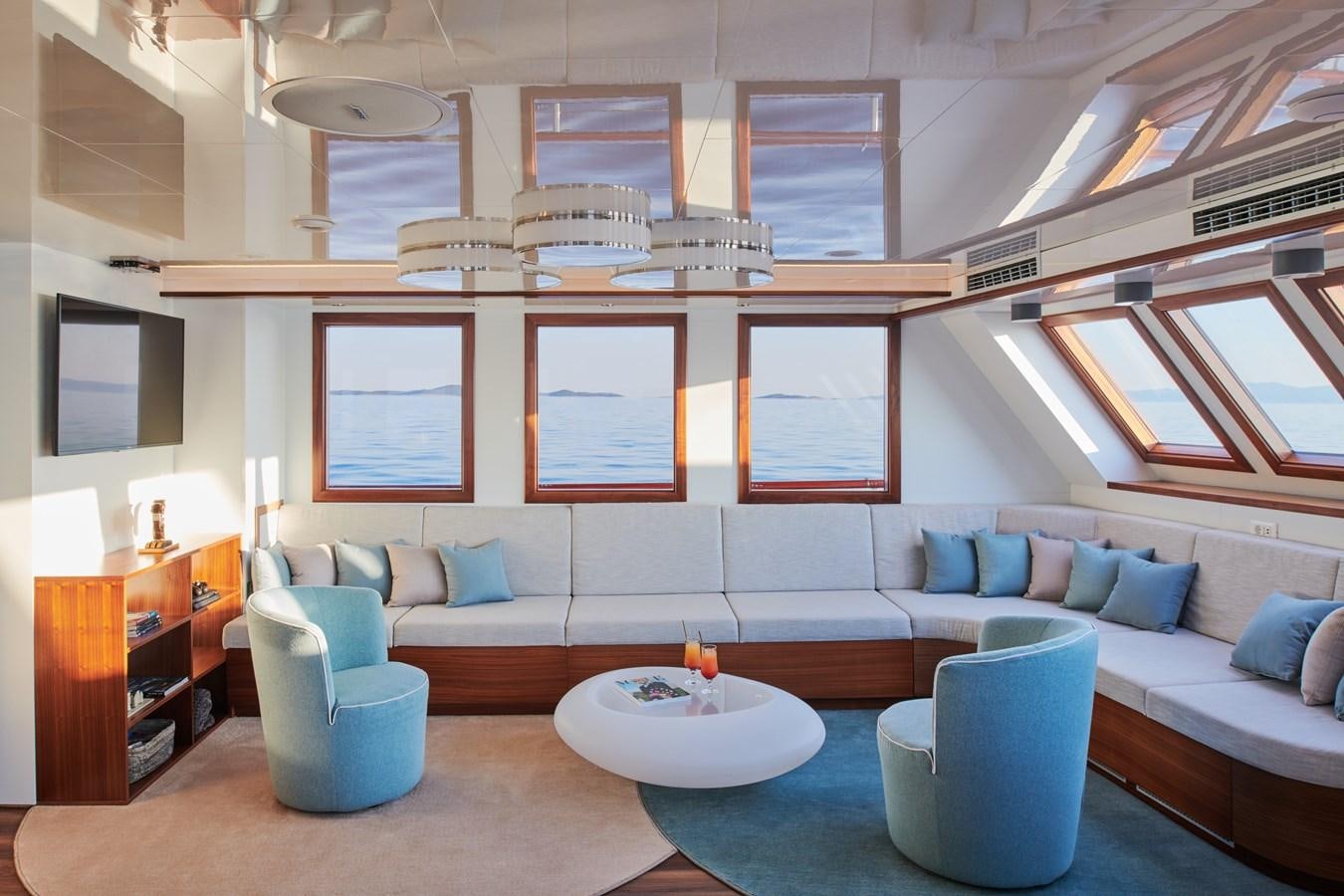 a room with a couch and a table aboard CORSARIO Yacht for Charter
