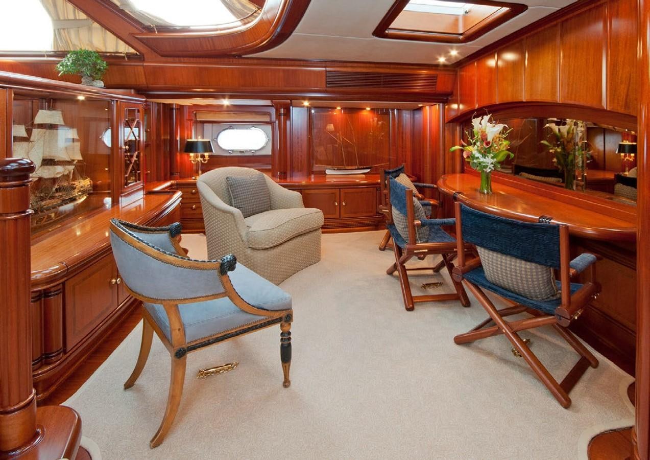 a living room with a table and chairs aboard HYPERION Yacht for Sale