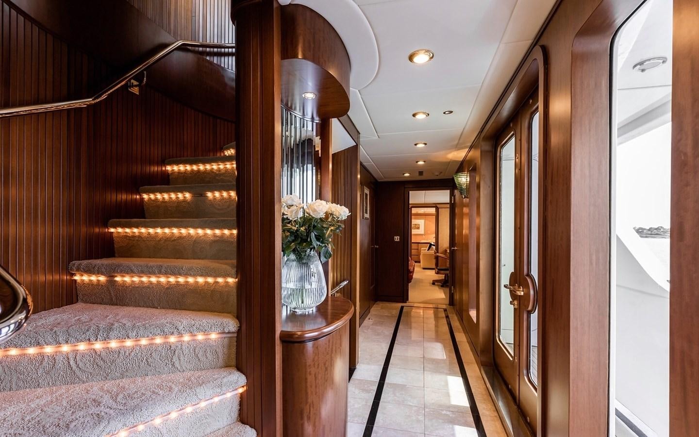 a living room with a wood staircase aboard SIERRA 2 Yacht for Sale