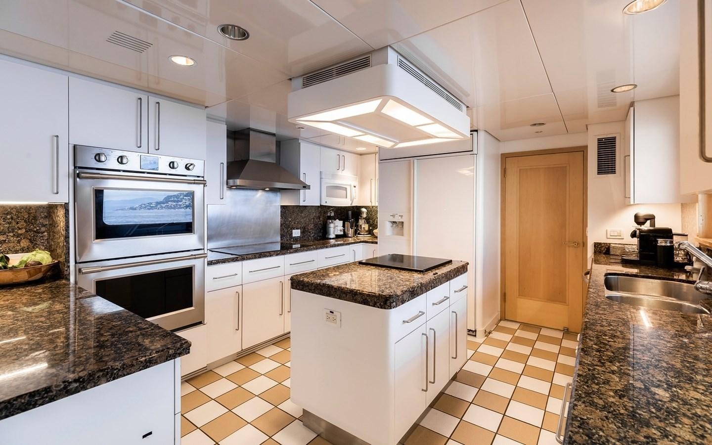 a kitchen with white cabinets aboard SIERRA 2 Yacht for Sale