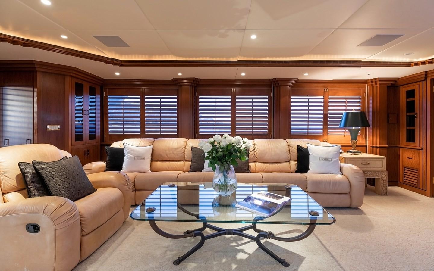 a living room with a table and couches aboard SIERRA 2 Yacht for Sale
