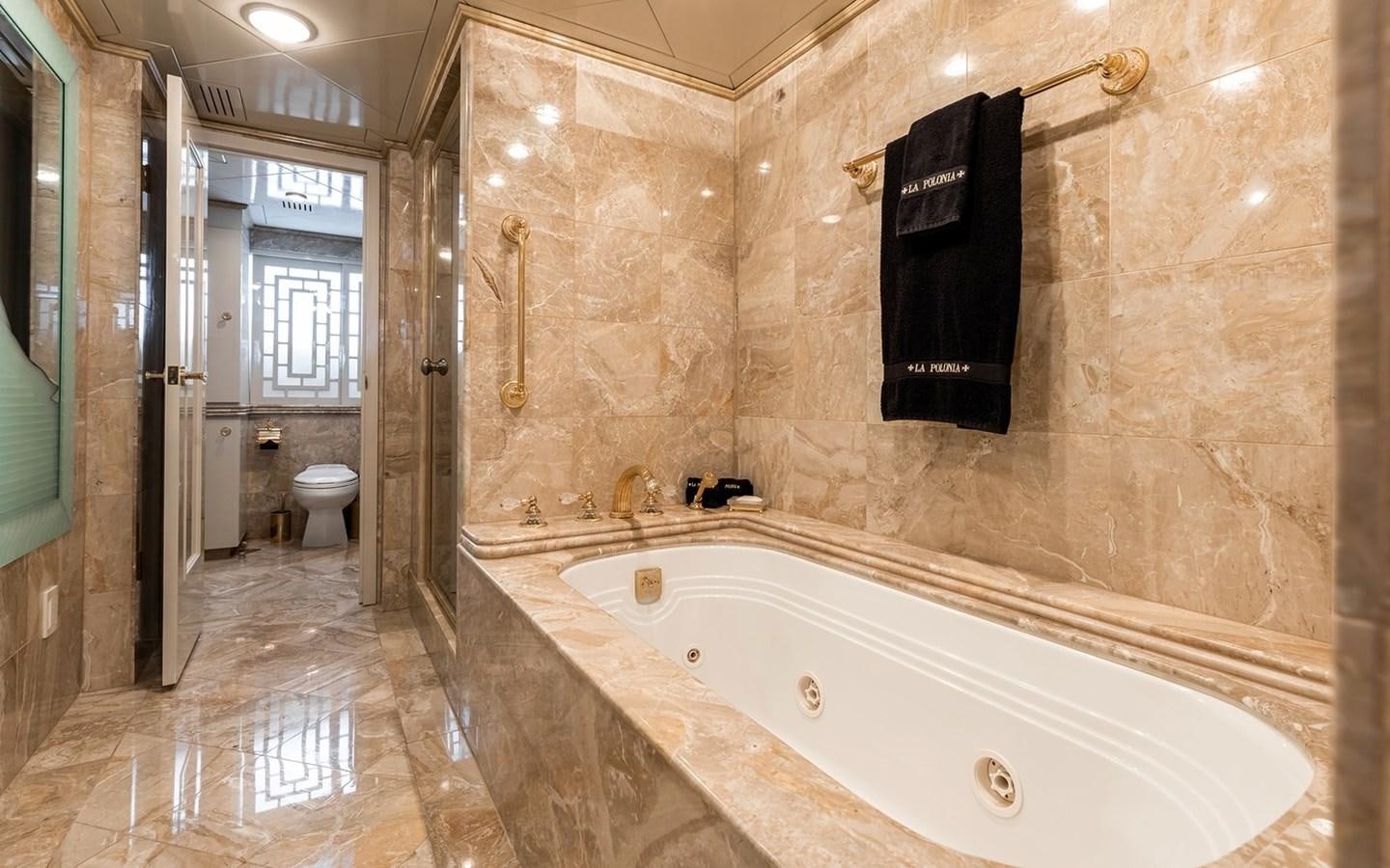 a bathroom with a tub and toilet aboard SIERRA 2 Yacht for Sale