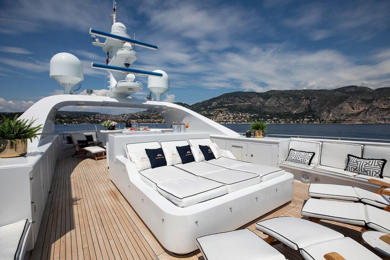 a deck with a large white boat and a white satellite dish on it aboard SIERRA 2 Yacht for Sale