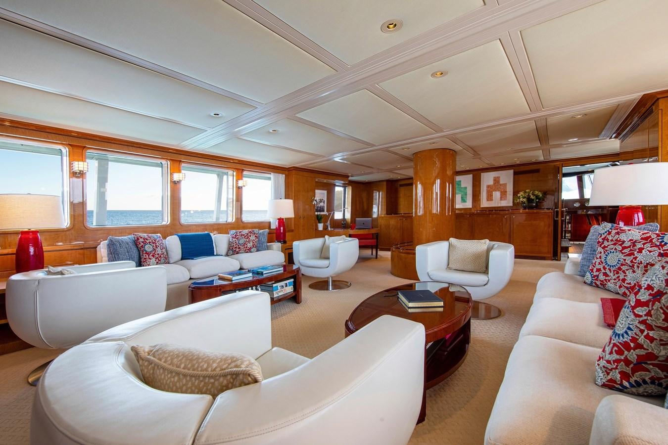 a living room with a couch and a coffee table aboard MIKADO Yacht for Sale