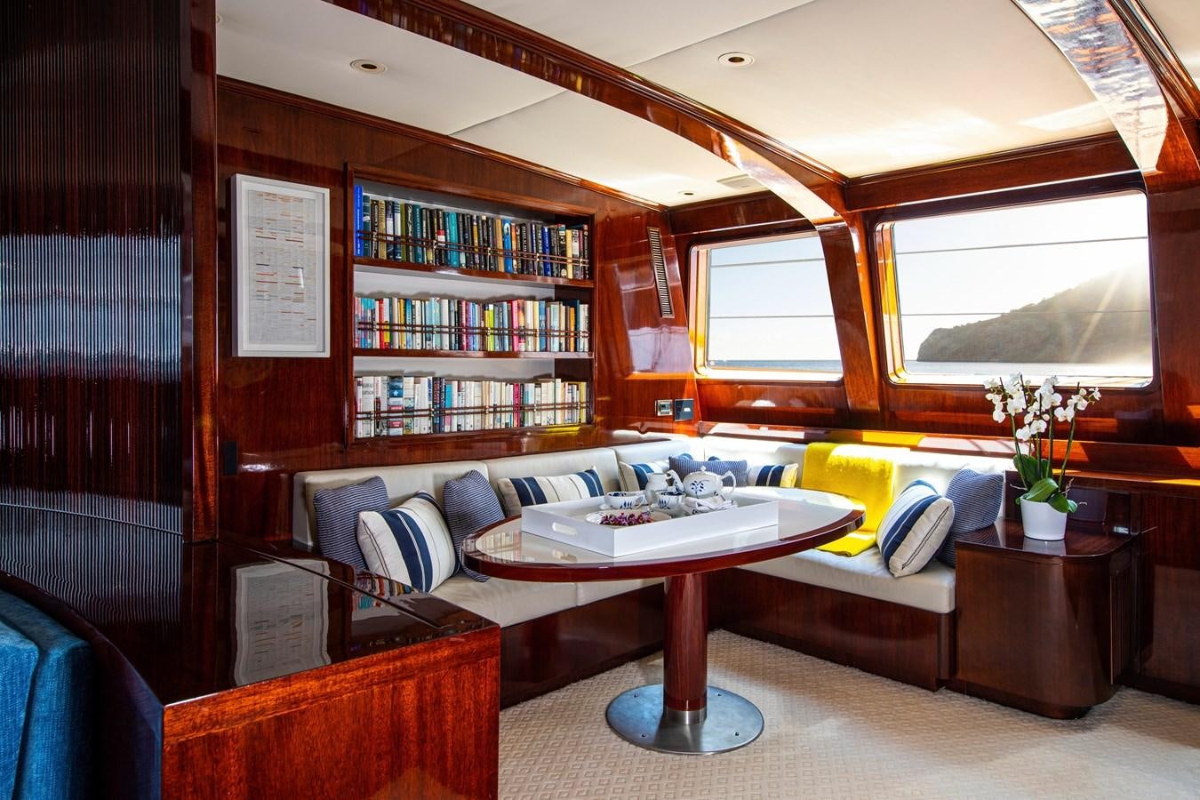 a living room with a bookcase aboard MIKADO Yacht for Sale