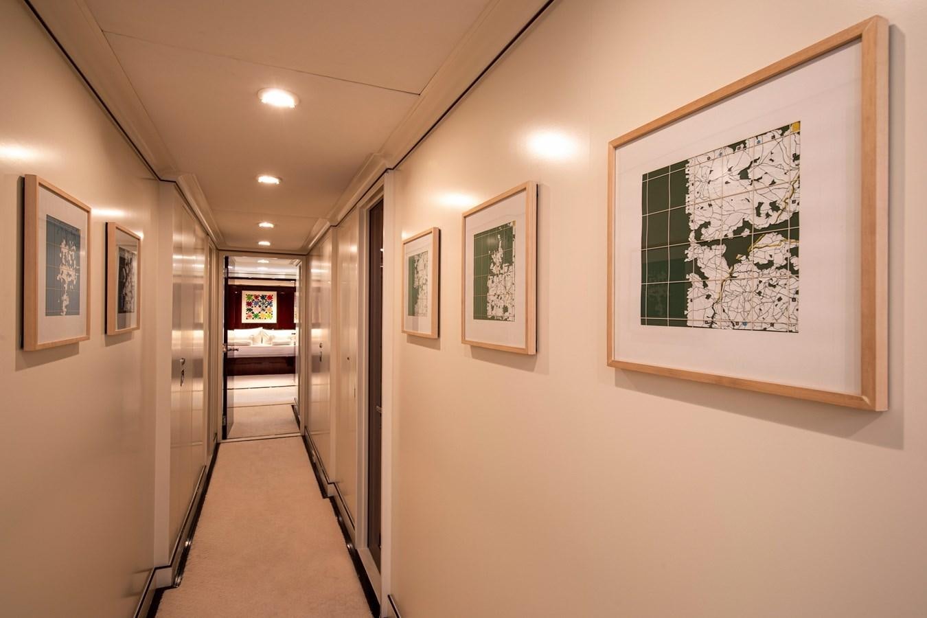a hallway with art on the wall aboard MIKADO Yacht for Sale