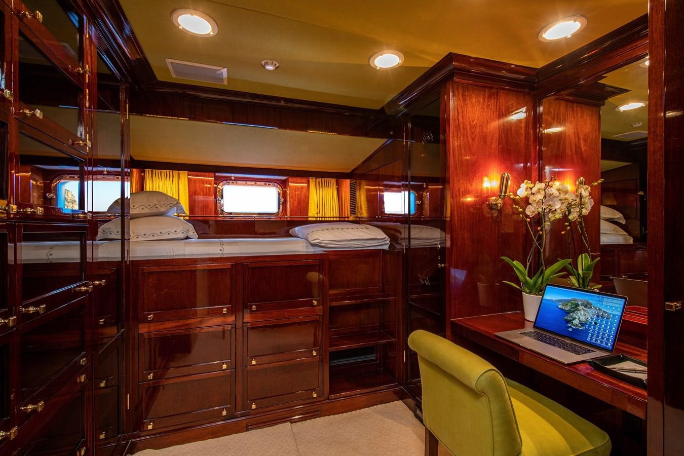 a room with a laptop and a bed aboard MIKADO Yacht for Sale