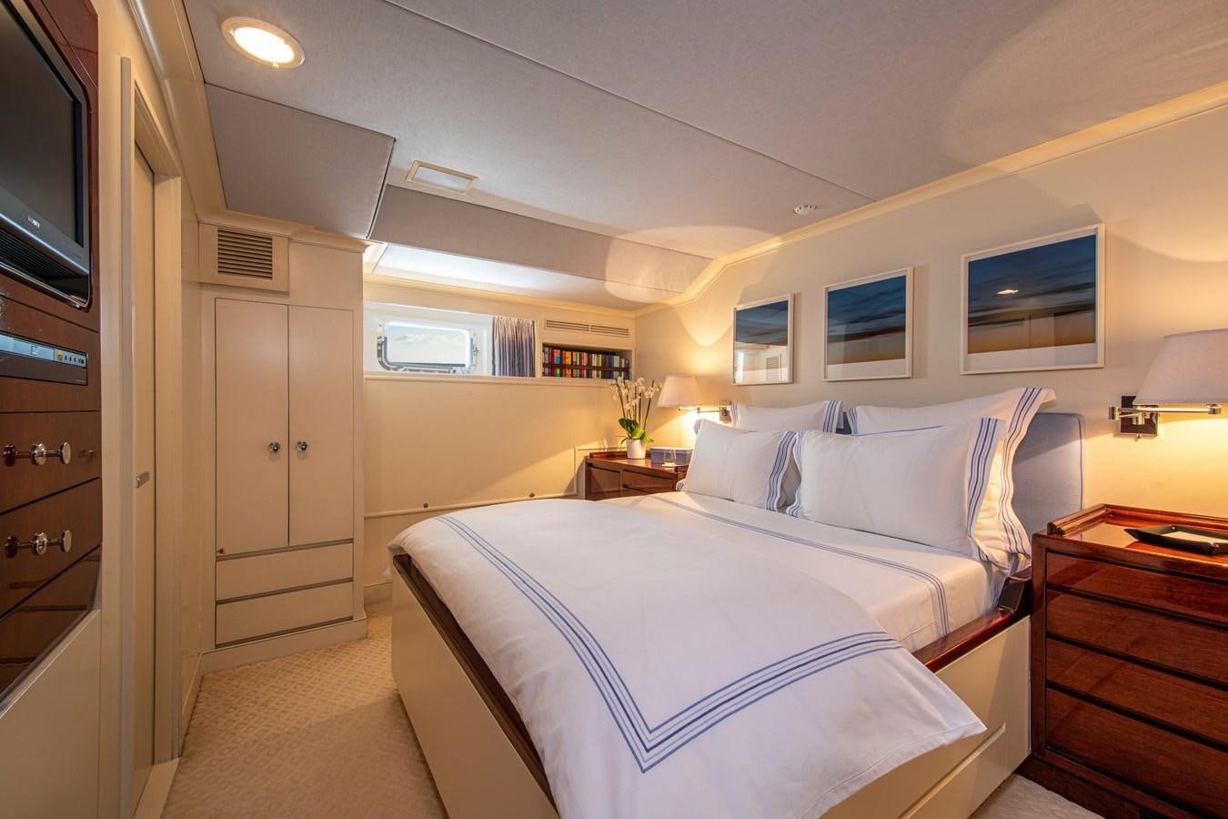 a bedroom with a bed and a television aboard MIKADO Yacht for Sale