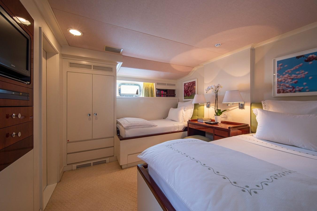 a bedroom with a bed and a television aboard MIKADO Yacht for Sale