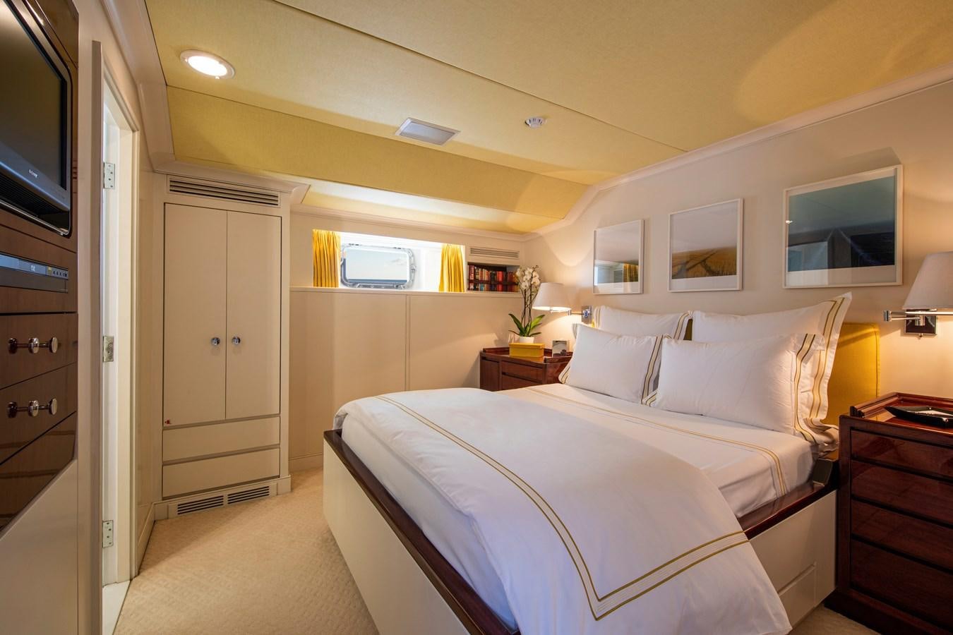 a bedroom with a bed and a television aboard MIKADO Yacht for Sale