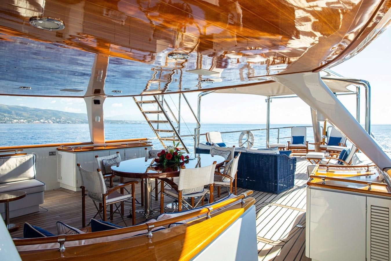 a boat with a table and chairs aboard MIKADO Yacht for Sale