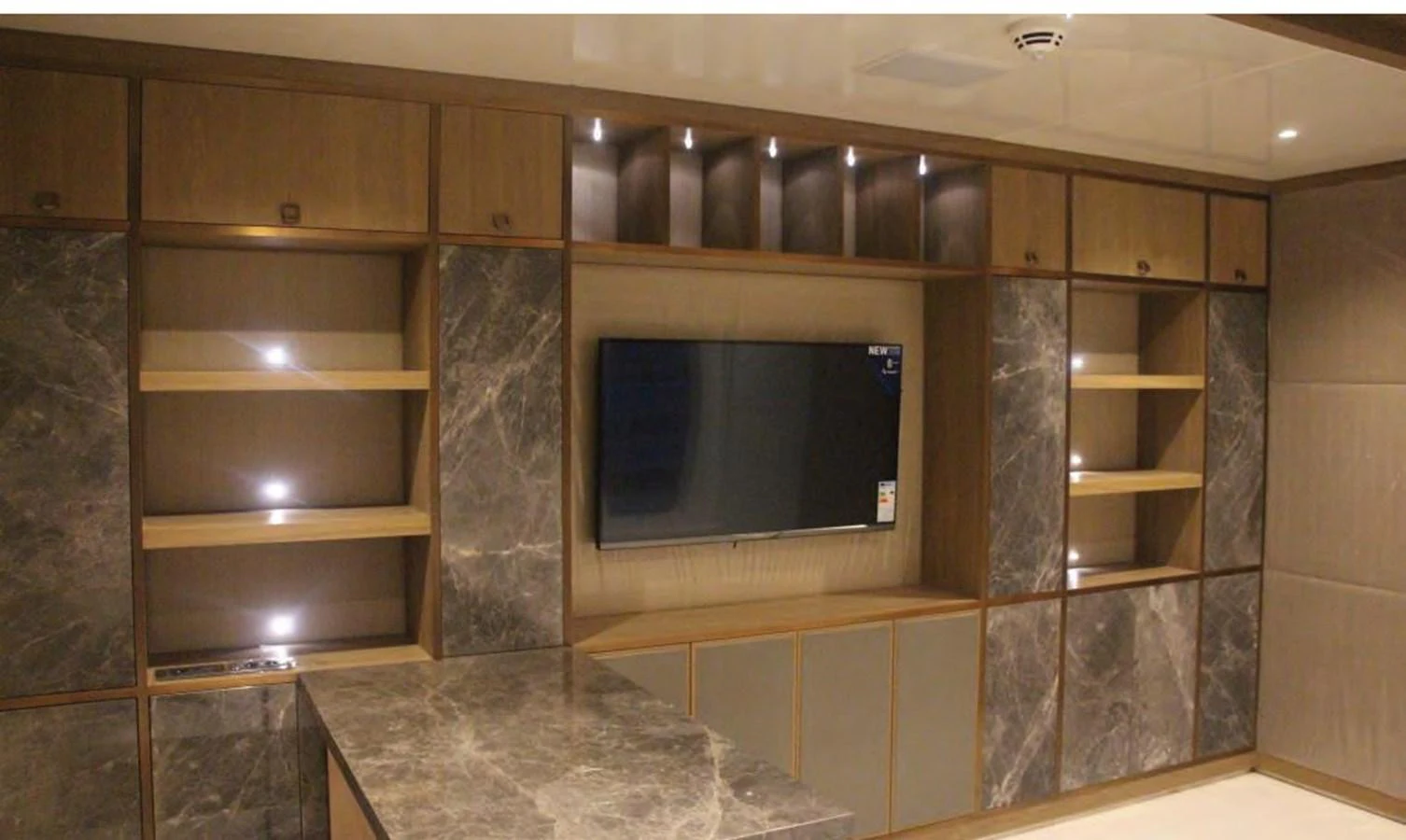 a room with a tv and shelves aboard HULL#05 Yacht for Sale