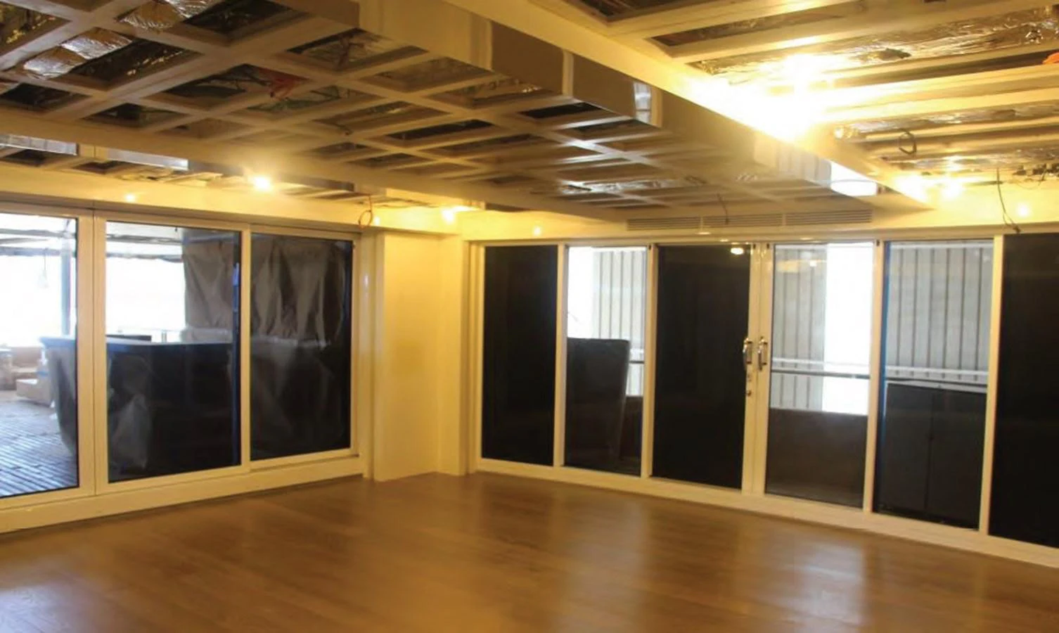 a room with a wood floor and a wood floor and a large window aboard HULL#05 Yacht for Sale
