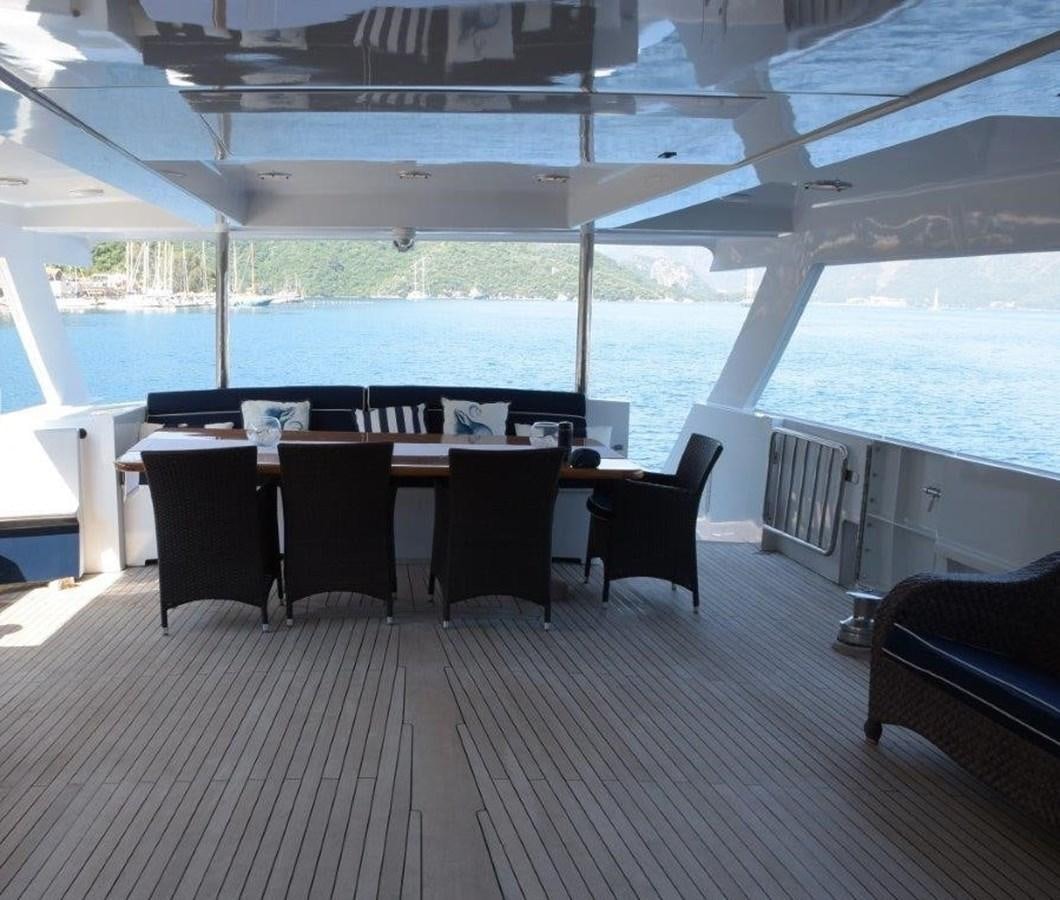 a room with a table and chairs aboard AGA 6 Yacht for Sale