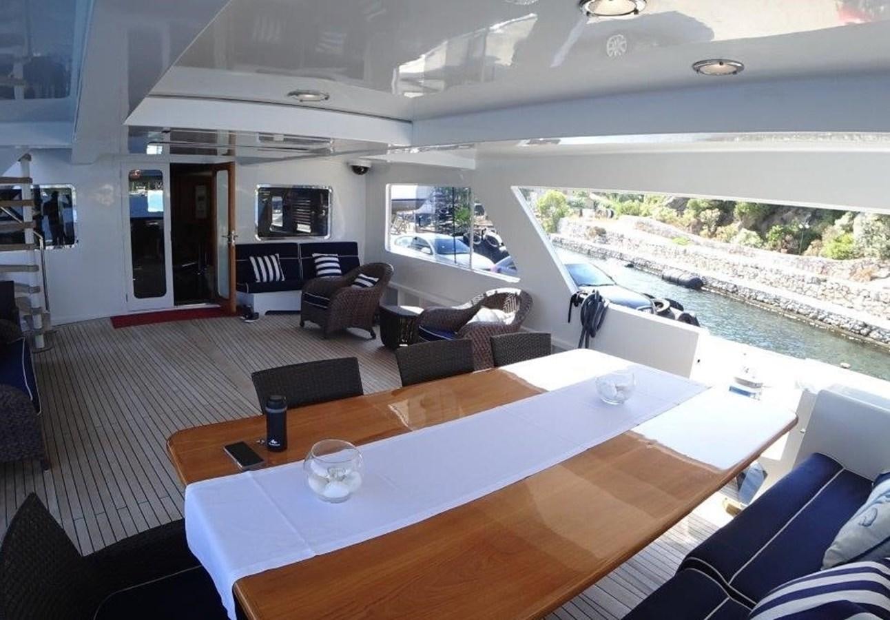a room with a table and chairs aboard AGA 6 Yacht for Sale