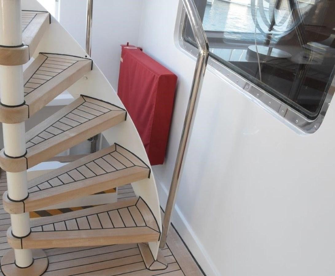 a white shelf with a red pillow on it aboard AGA 6 Yacht for Sale