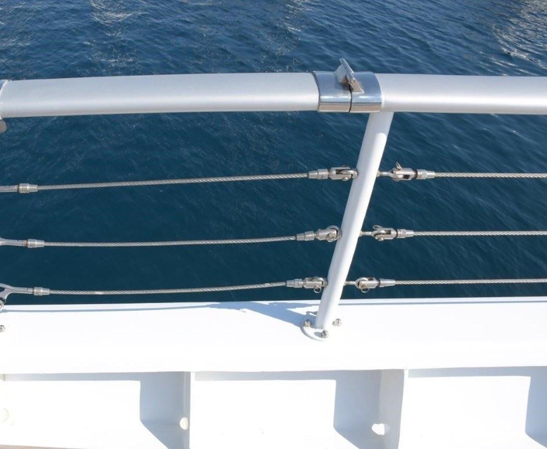 a white railing with a blue wall aboard AGA 6 Yacht for Sale