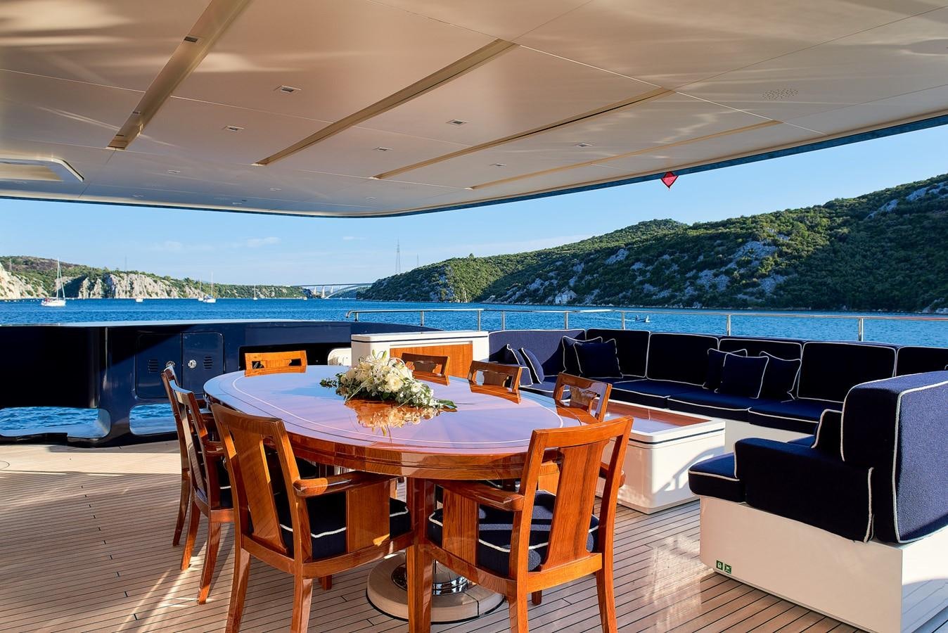 a table and chairs on a deck aboard REVE D’OR Yacht for Sale