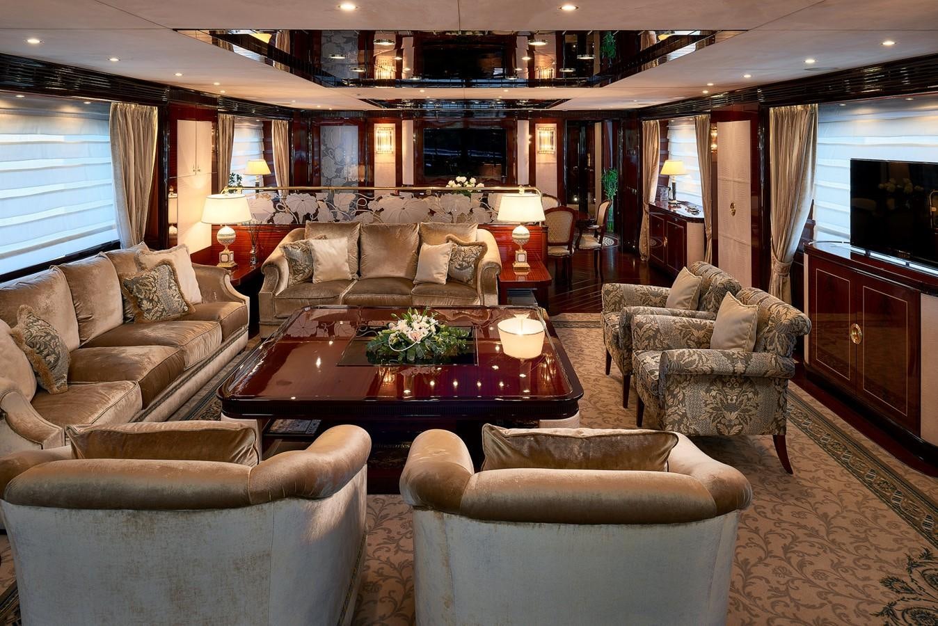 a living room with a table and chairs aboard REVE D’OR Yacht for Sale