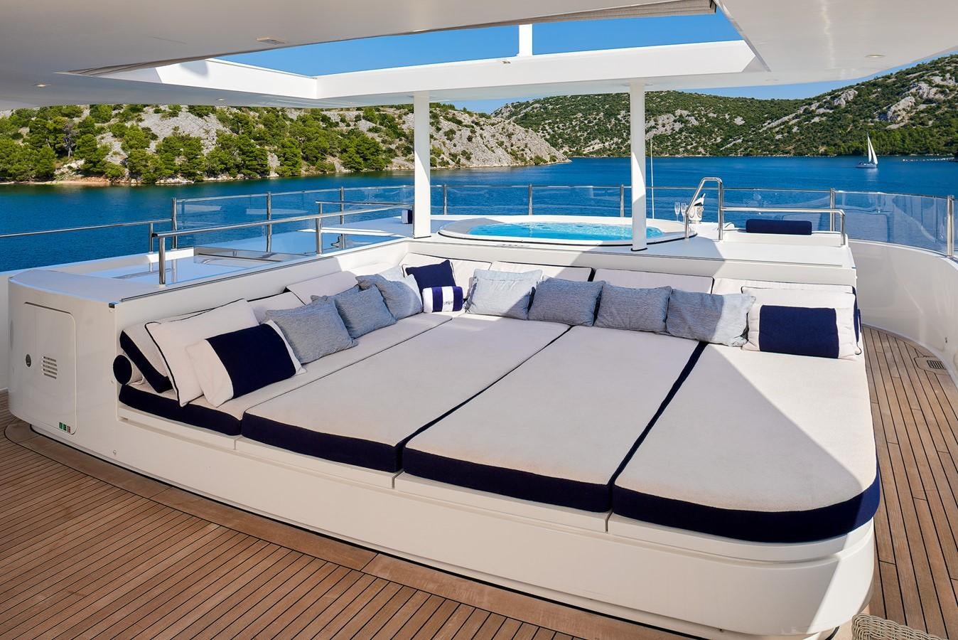 a large white bed on a deck aboard REVE D’OR Yacht for Sale