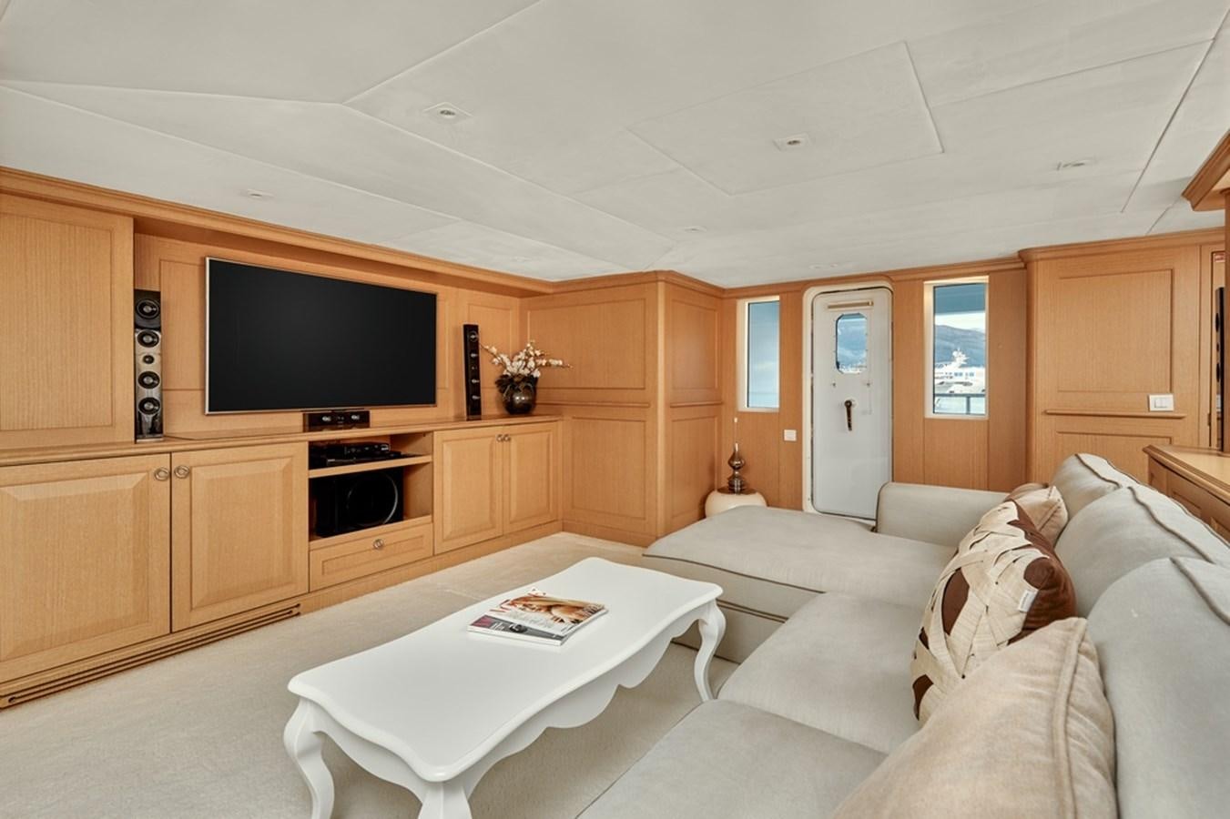 a living room with a tv and furniture aboard DEEP STORY Yacht for Sale