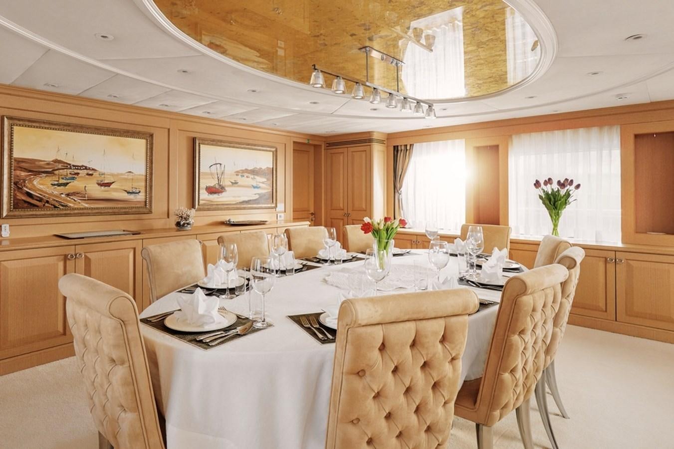 a dining room with a table set aboard DEEP STORY Yacht for Sale