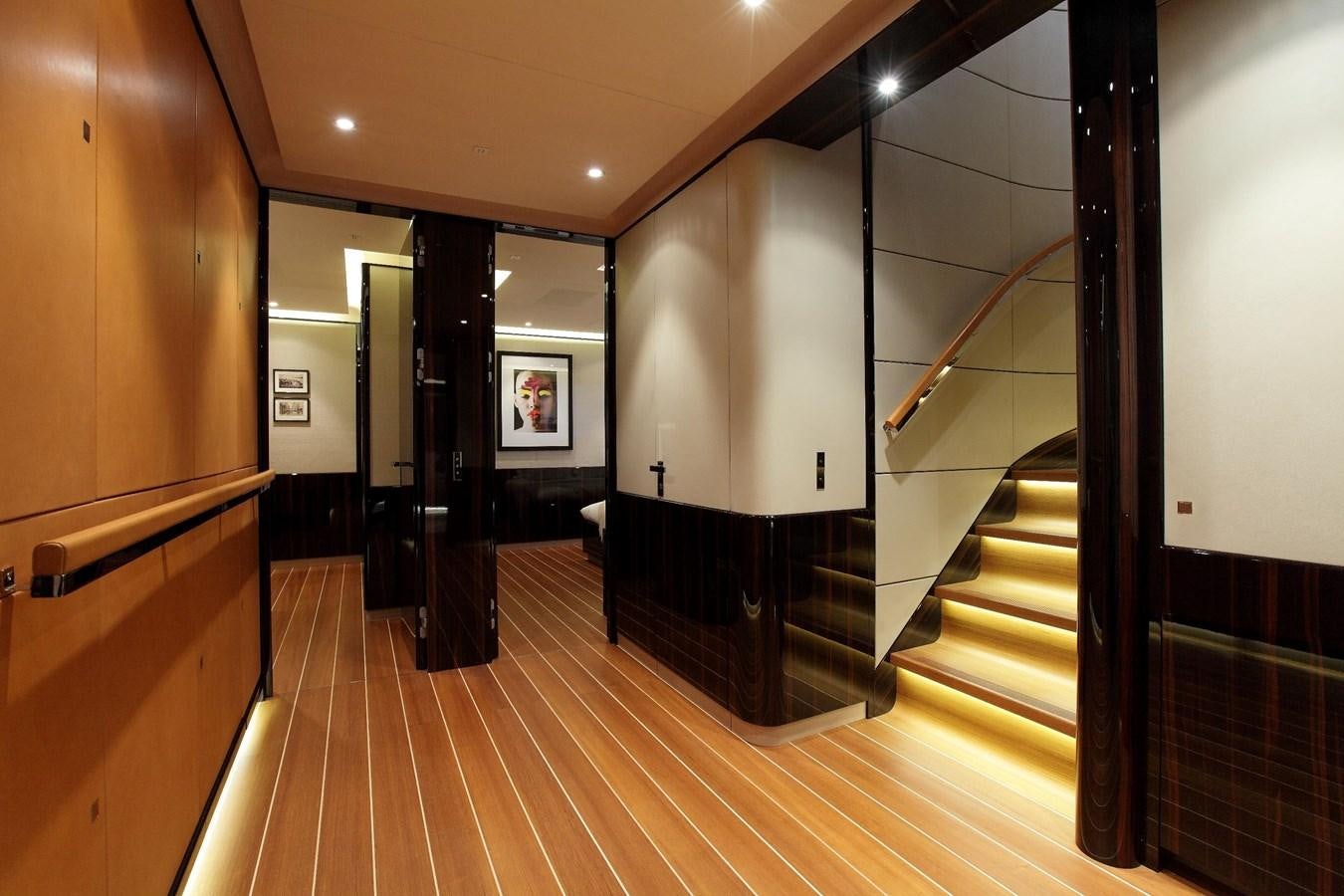 a hallway with wood floors and a staircase aboard SERENDIPITY I Yacht for Sale