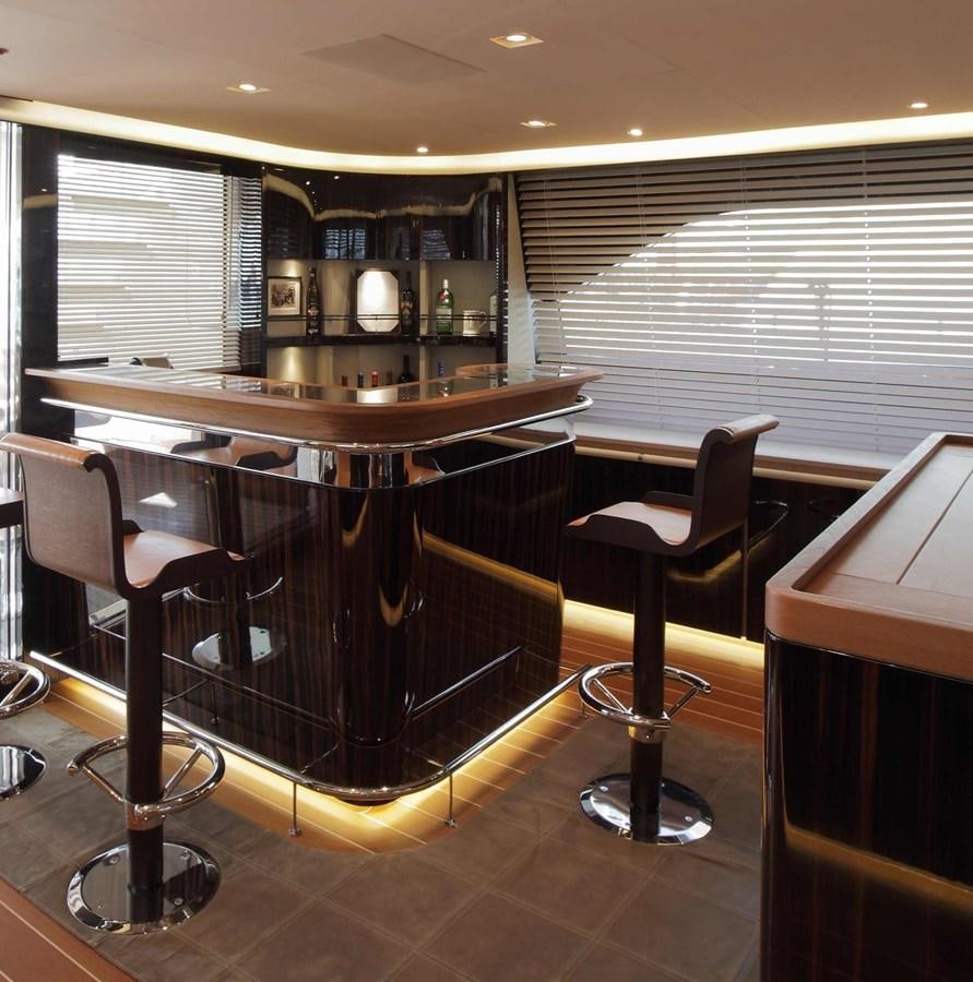 a bar with a bar and chairs aboard SERENDIPITY I Yacht for Sale