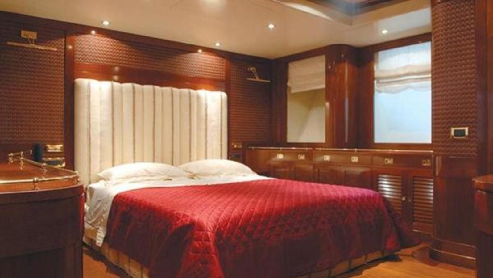 a room with a bed and a window aboard ARIETE PRIMO Yacht for Sale