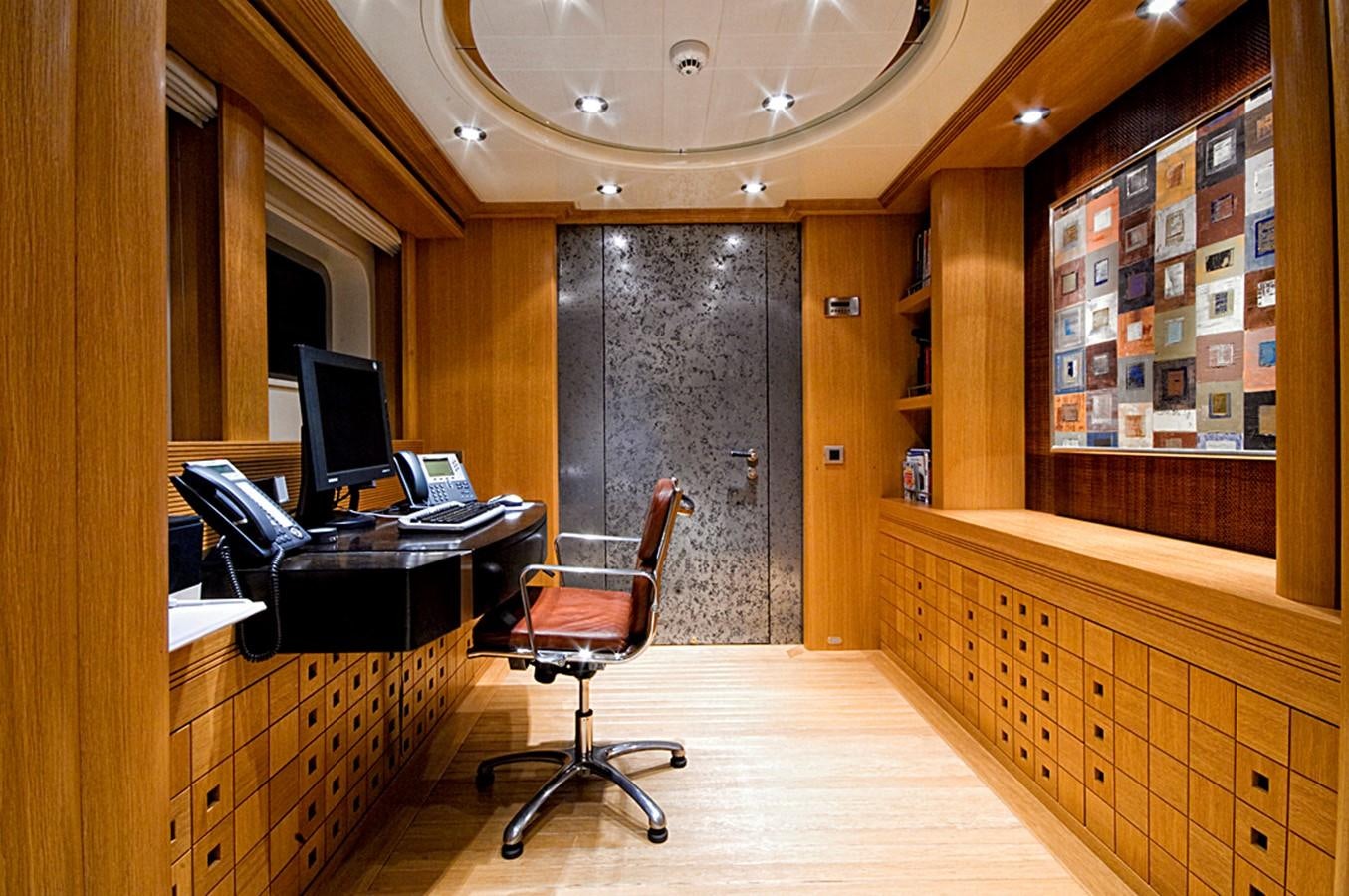 a room with a desk and computer aboard KIJO Yacht for Charter