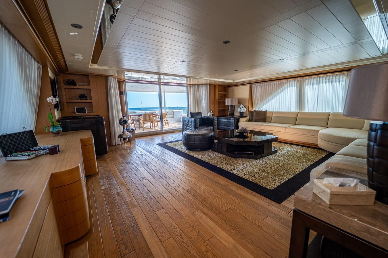 a living room with a large window aboard KIJO Yacht for Charter