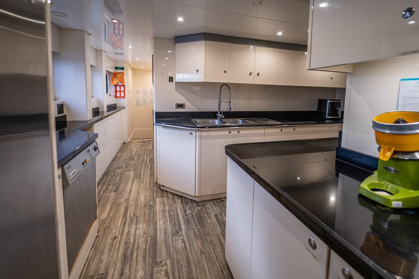a kitchen with a wood floor aboard KIJO Yacht for Charter