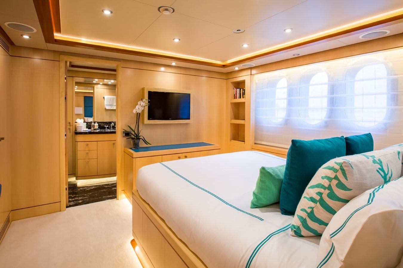 a bedroom with a bed and a tv aboard BLUE VISION Yacht for Sale