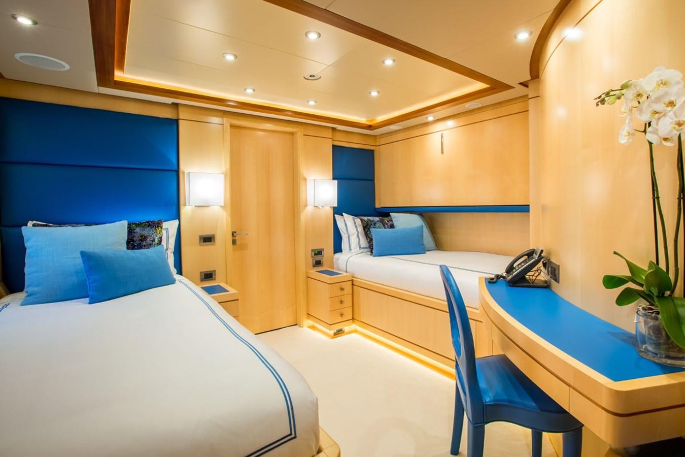 a room with beds and a desk aboard BLUE VISION Yacht for Sale