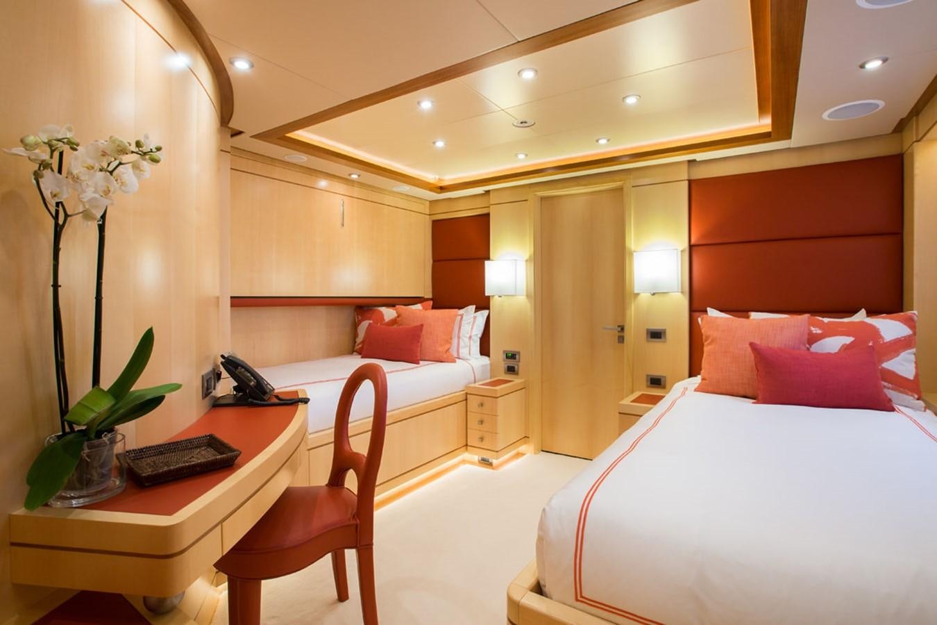 a room with a bed and desk aboard BLUE VISION Yacht for Sale