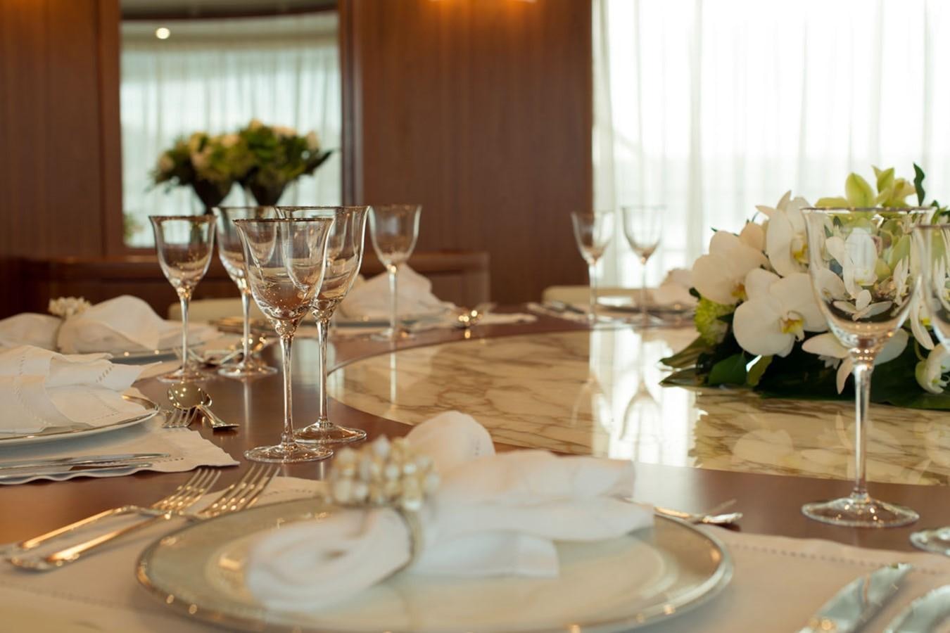a table with plates and glasses aboard BLUE VISION Yacht for Sale