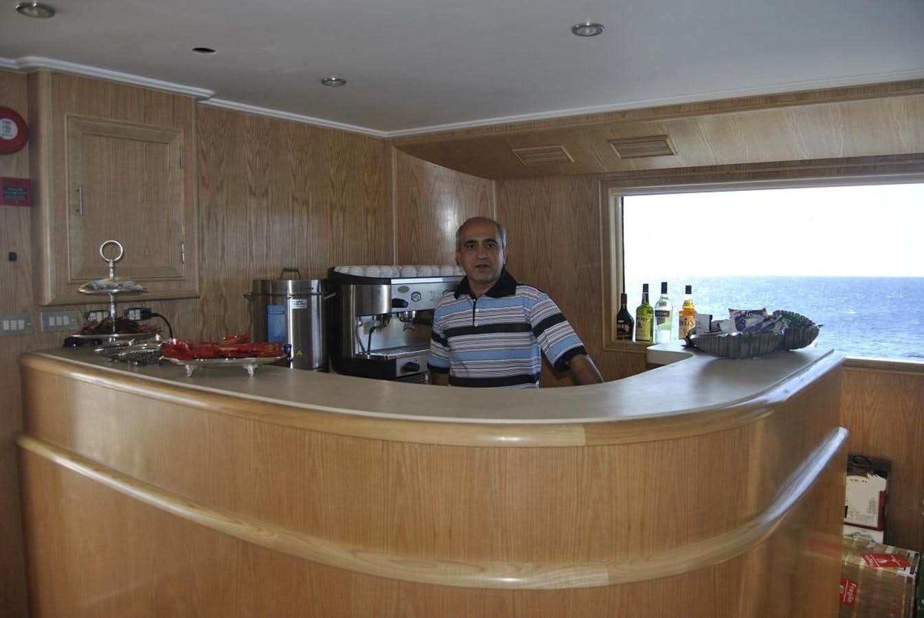 a person standing behind a counter aboard SCUBA SCENE Yacht for Sale