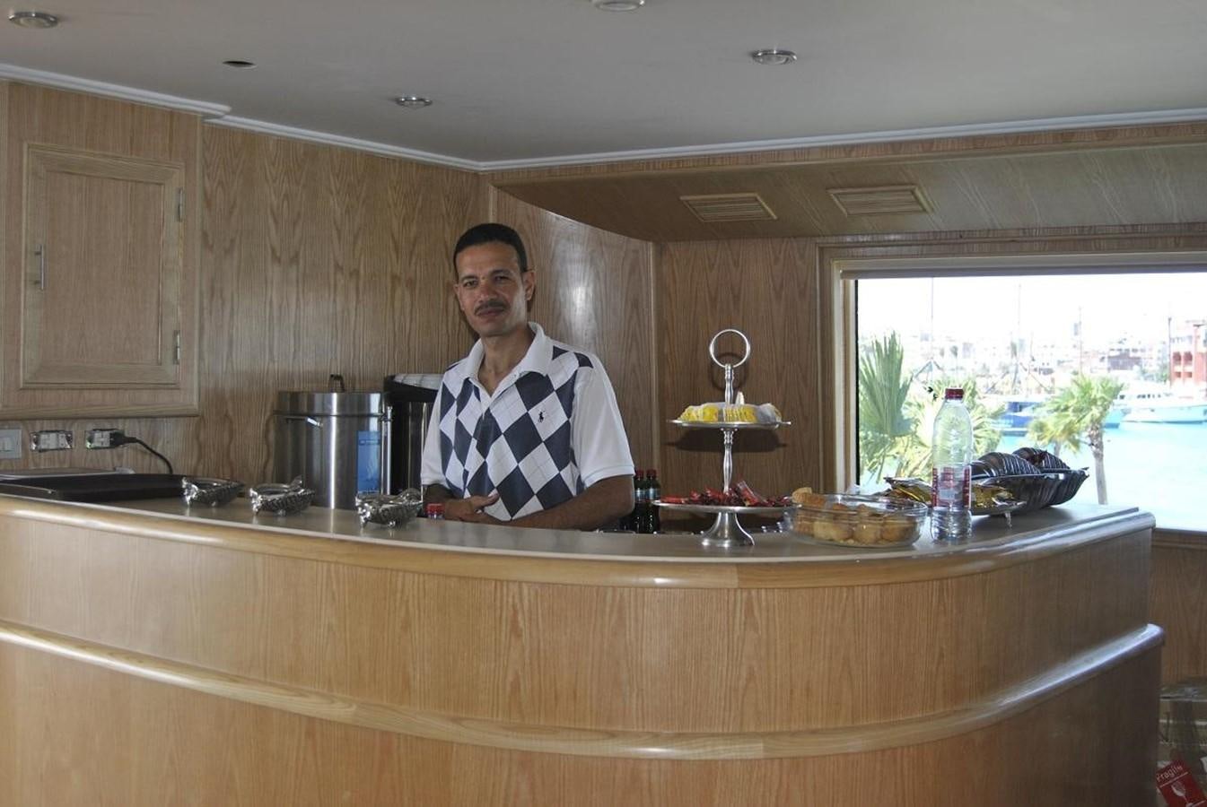 a person standing in a kitchen aboard SCUBA SCENE Yacht for Sale