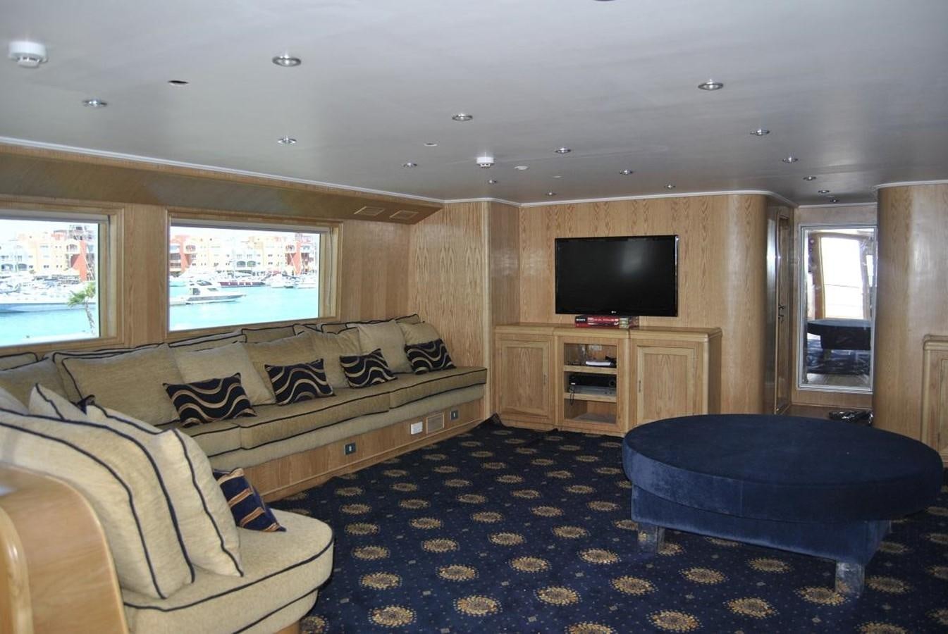 a living room with a couch and a tv aboard SCUBA SCENE Yacht for Sale