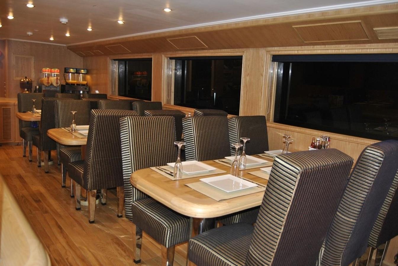 a restaurant with a table and chairs aboard SCUBA SCENE Yacht for Sale