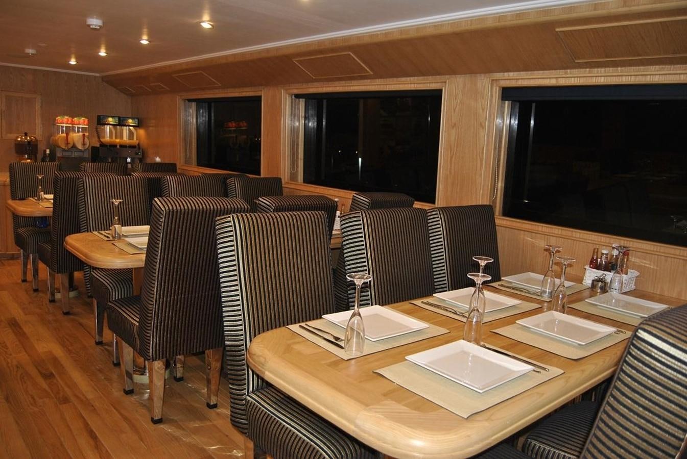 a restaurant with a table and chairs aboard SCUBA SCENE Yacht for Sale