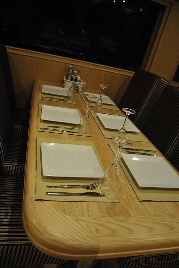 a table with a plate and glasses aboard SCUBA SCENE Yacht for Sale