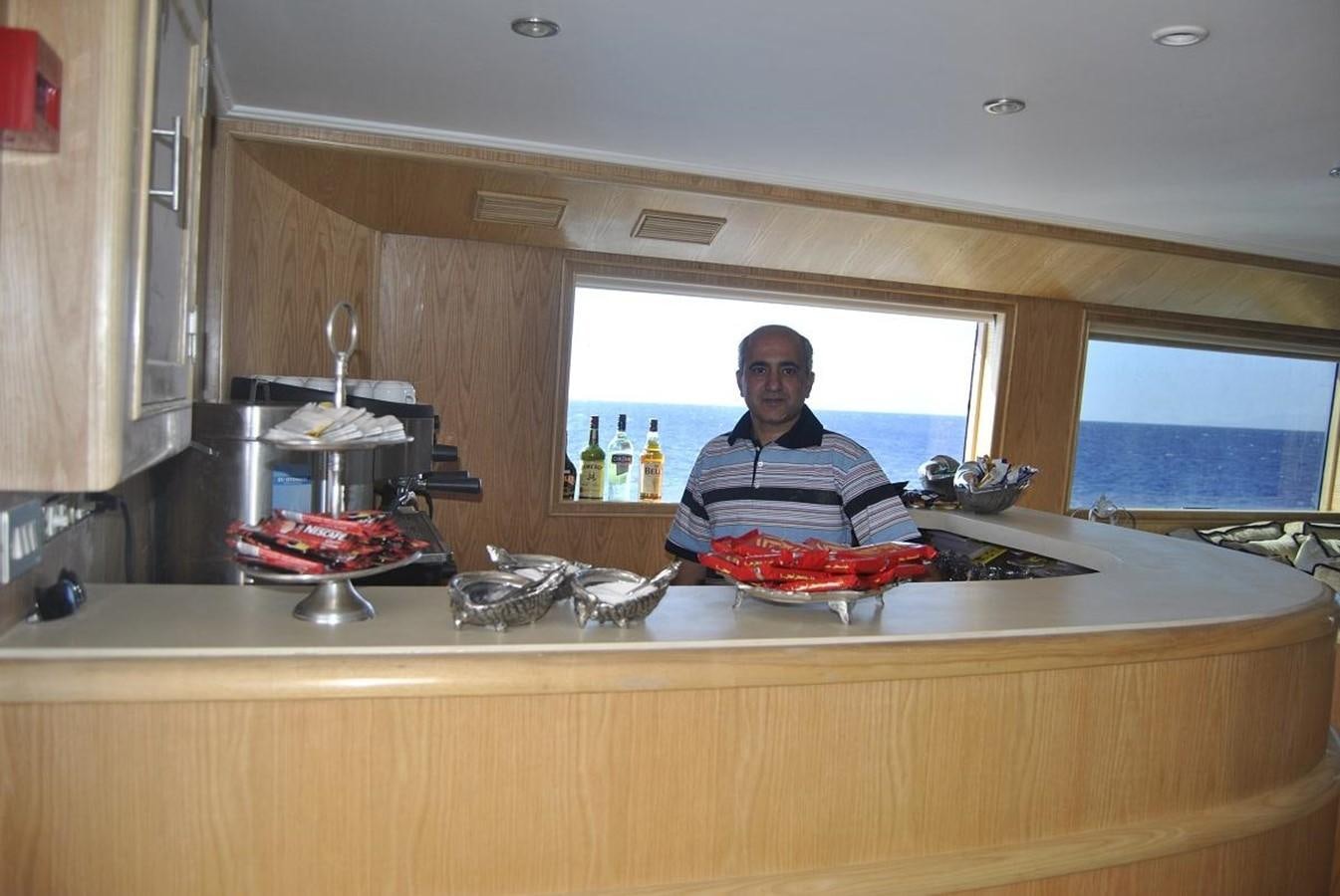 a person cooking in a kitchen aboard SCUBA SCENE Yacht for Sale
